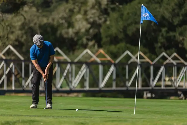 Golfer putting out on a green at Avila Beach