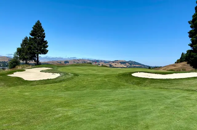 Bunkered fairway with the hills beyond at Canyon Lakes