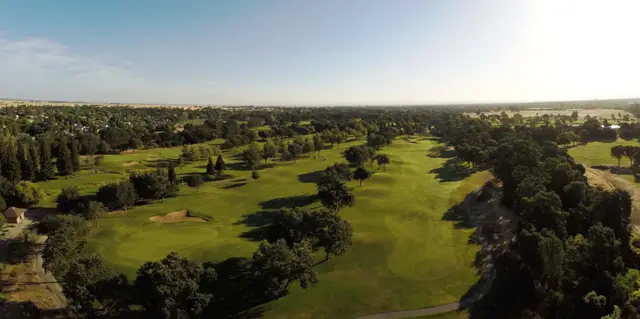 Aerial view down an oak-lined fairway at Cherry Island