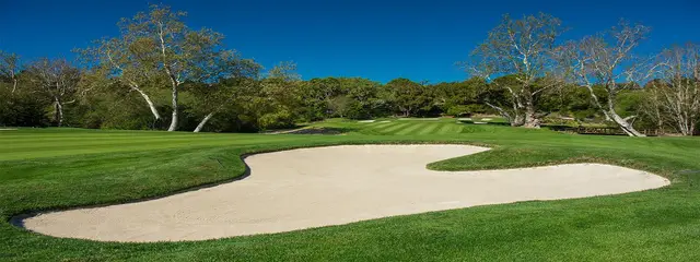Greenside bunker under a clear sky