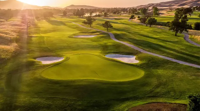 Sunrise over bunkered greens at Coyote Creek