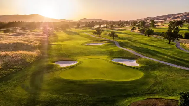 Low sun across a green at Coyote Creek