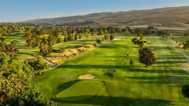 Tree-lined fairways below the eastern hills