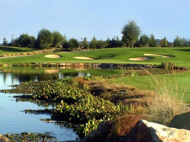Wetland pond in front of a bunkered green