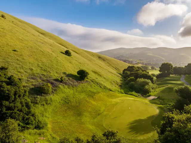 Green tucked into a grassy valley
