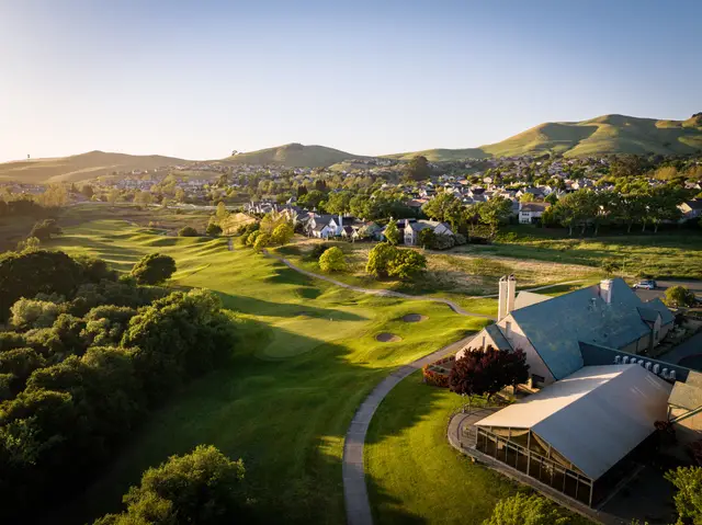 Aerial view of the clubhouse and course at sunrise