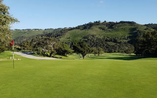 Green below the oak-covered hills at Laguna Seca Golf Ranch
