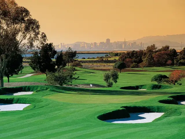 Bunkered greens with the San Francisco skyline beyond