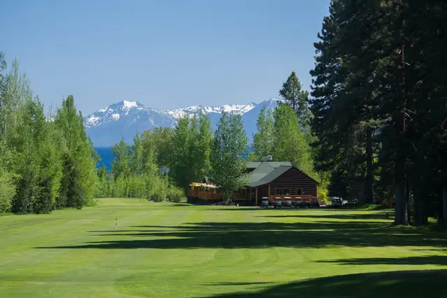 Fairway toward the clubhouse with snowcapped peaks beyond