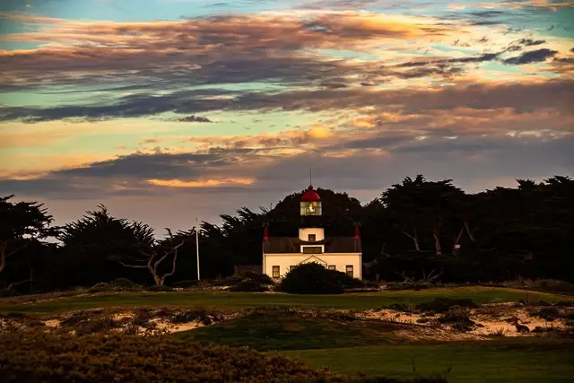 Point Pinos Lighthouse at sunset above the course