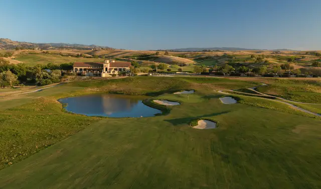 Pond and bunkers below the clubhouse at sunset