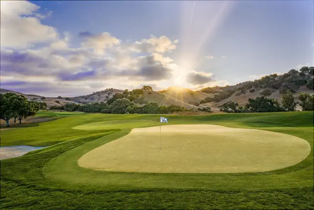 Sunburst over a green at San Juan Oaks