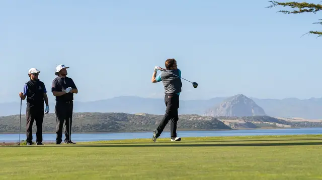 Golfer teeing off with Morro Rock in the distance