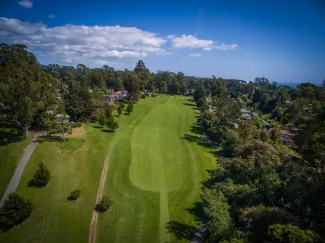 Aerial view down a fairway toward Monterey Bay