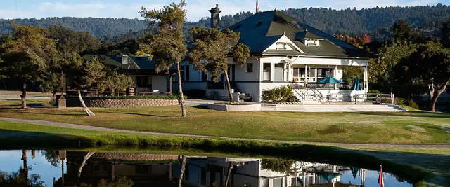 Spring Hills clubhouse reflected in the pond