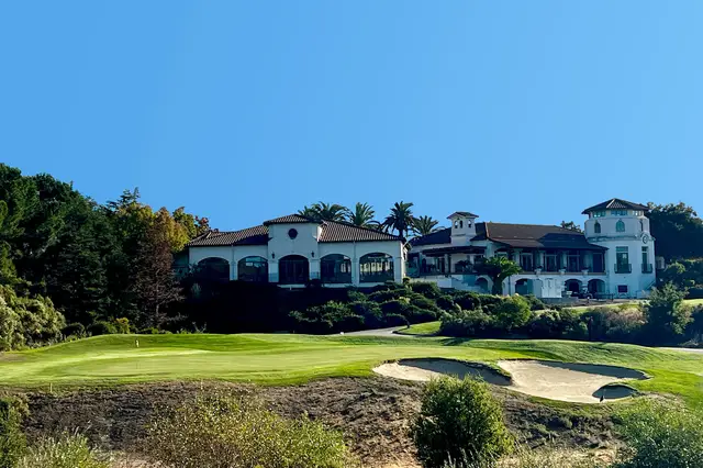 The Bridges clubhouse above a bunkered green