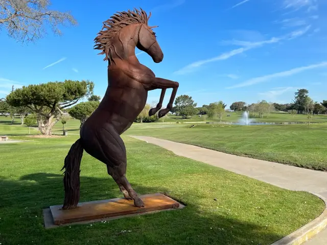 Rearing horse sculpture beside the course